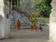 Monks sweeping the monastery grounds